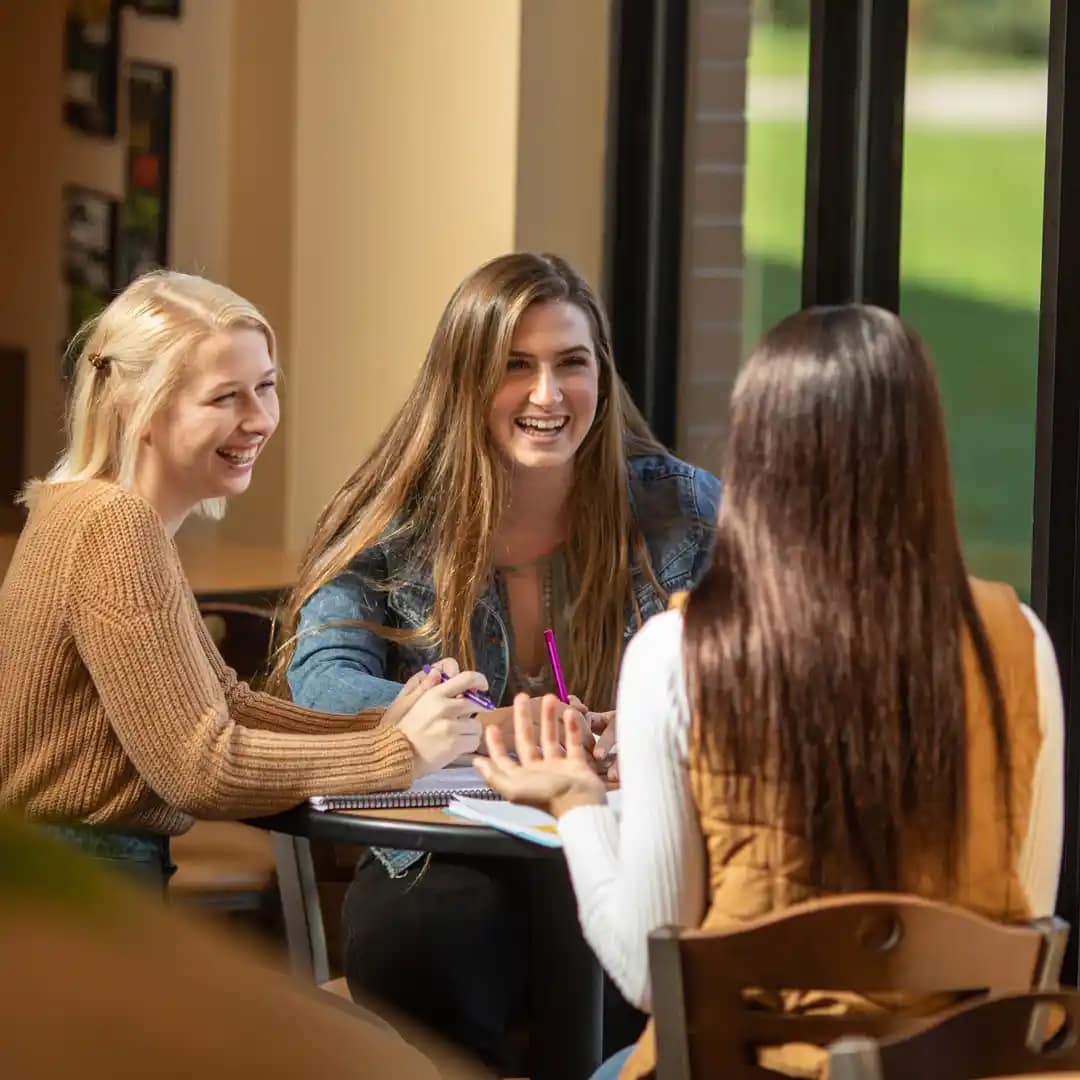 Grace-students-studying A group of Grace Students studying around a table in the Commons