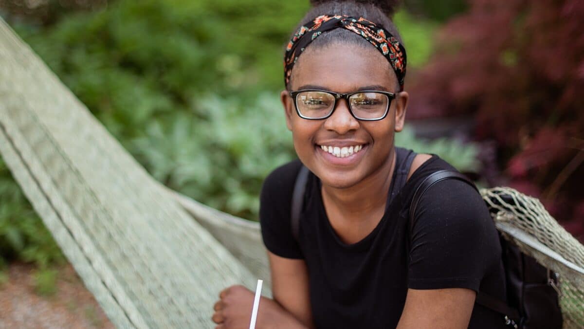 Giving-to-Grace Student smiling at the camera outside