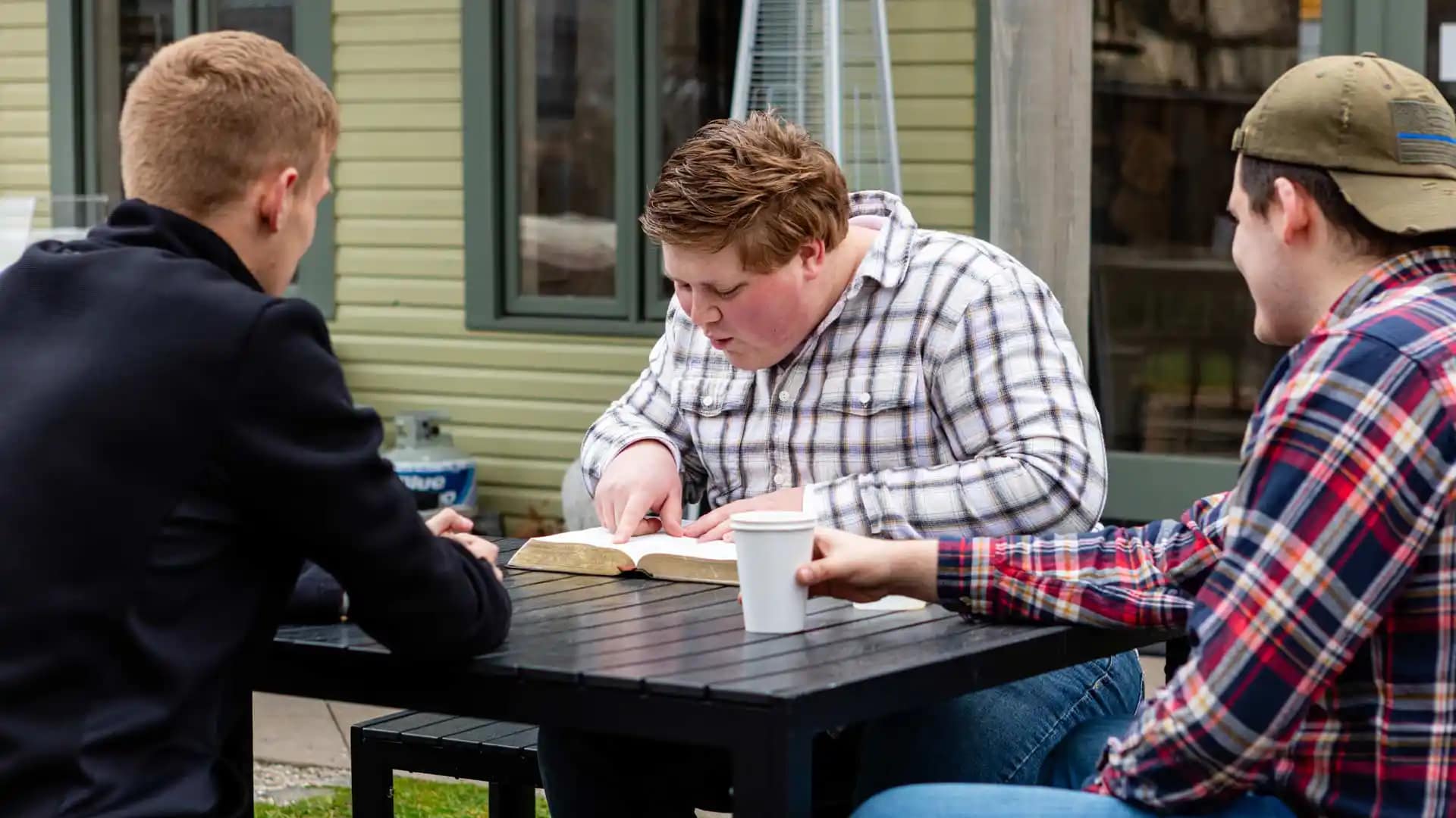 Grace-On-Campus-Students-5 Grace students sitting outside doing a bible study